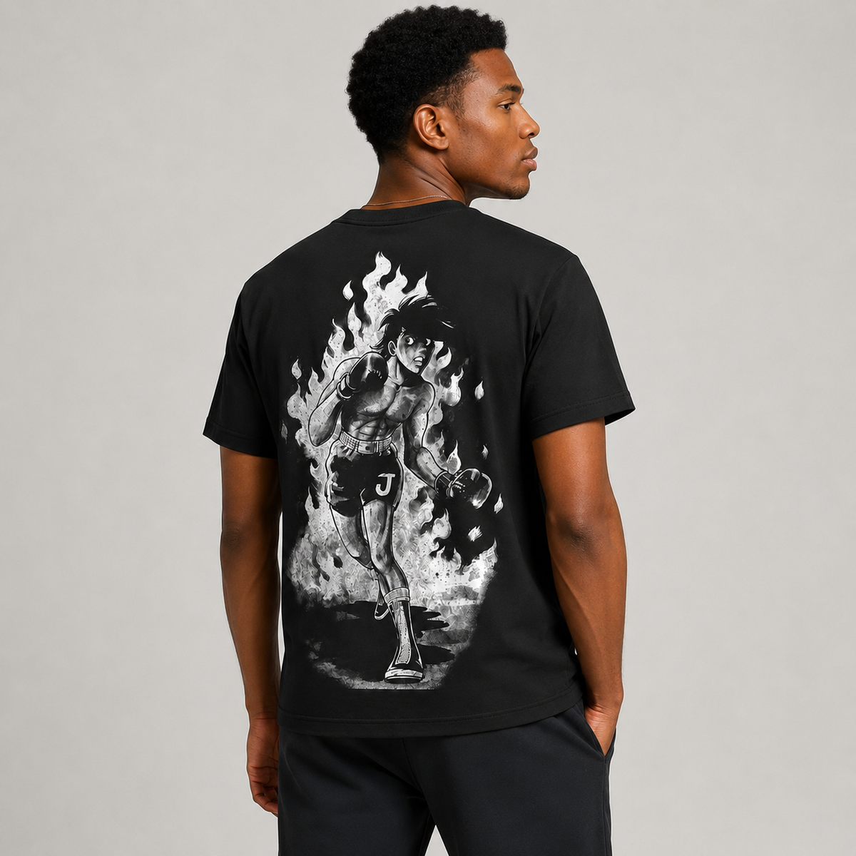 Japanese-style dark anime oversized T-shirt—distressed charcoal black, 100% cotton, featuring a large *Chainsaw Man* print and a vintage casual aesthetic.
