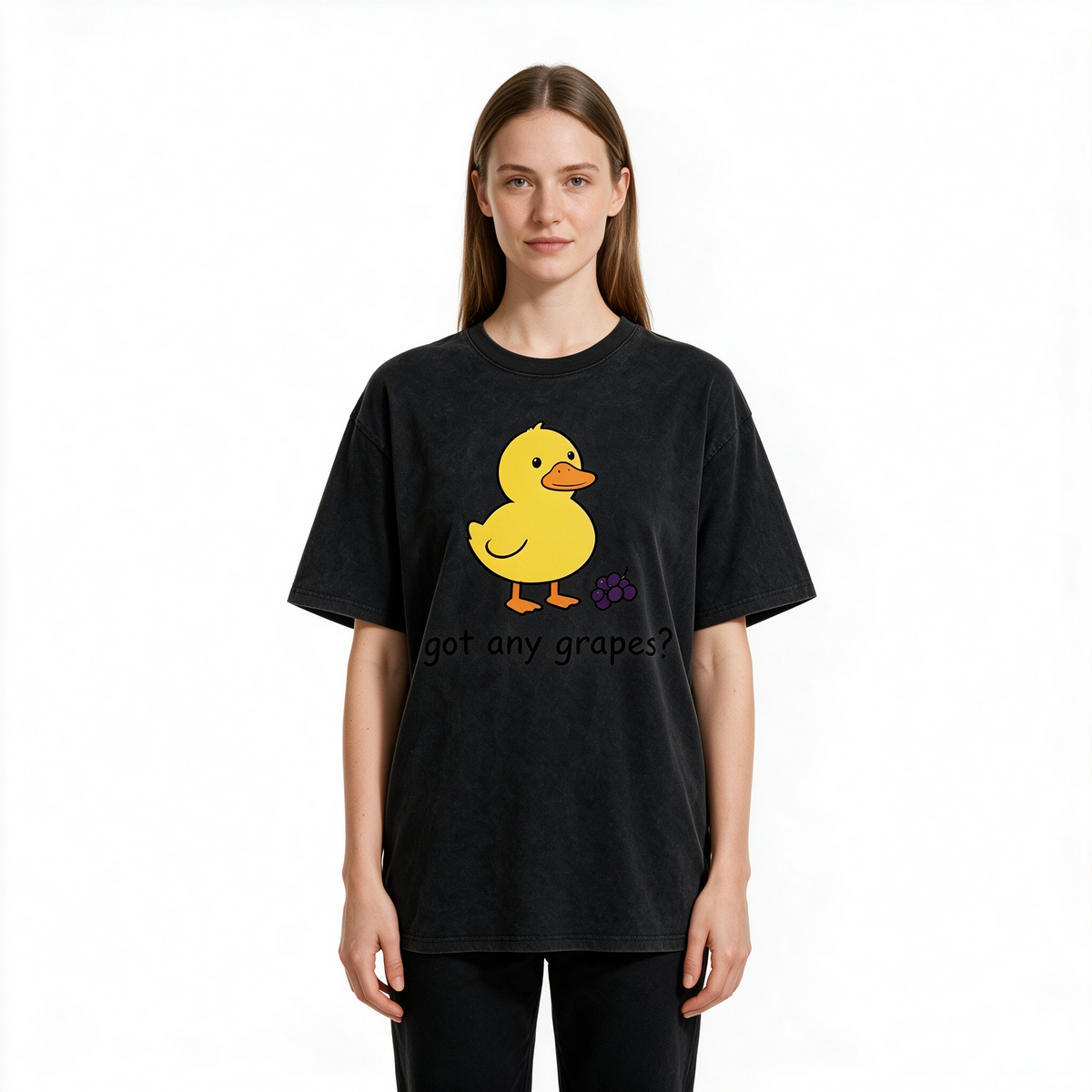 Vintage-style washed cotton T-shirt for women; features a cute graphic of a little yellow duck with grapes and playful English text; designed with a relaxed, drop-shoulder fit and short sleeves.