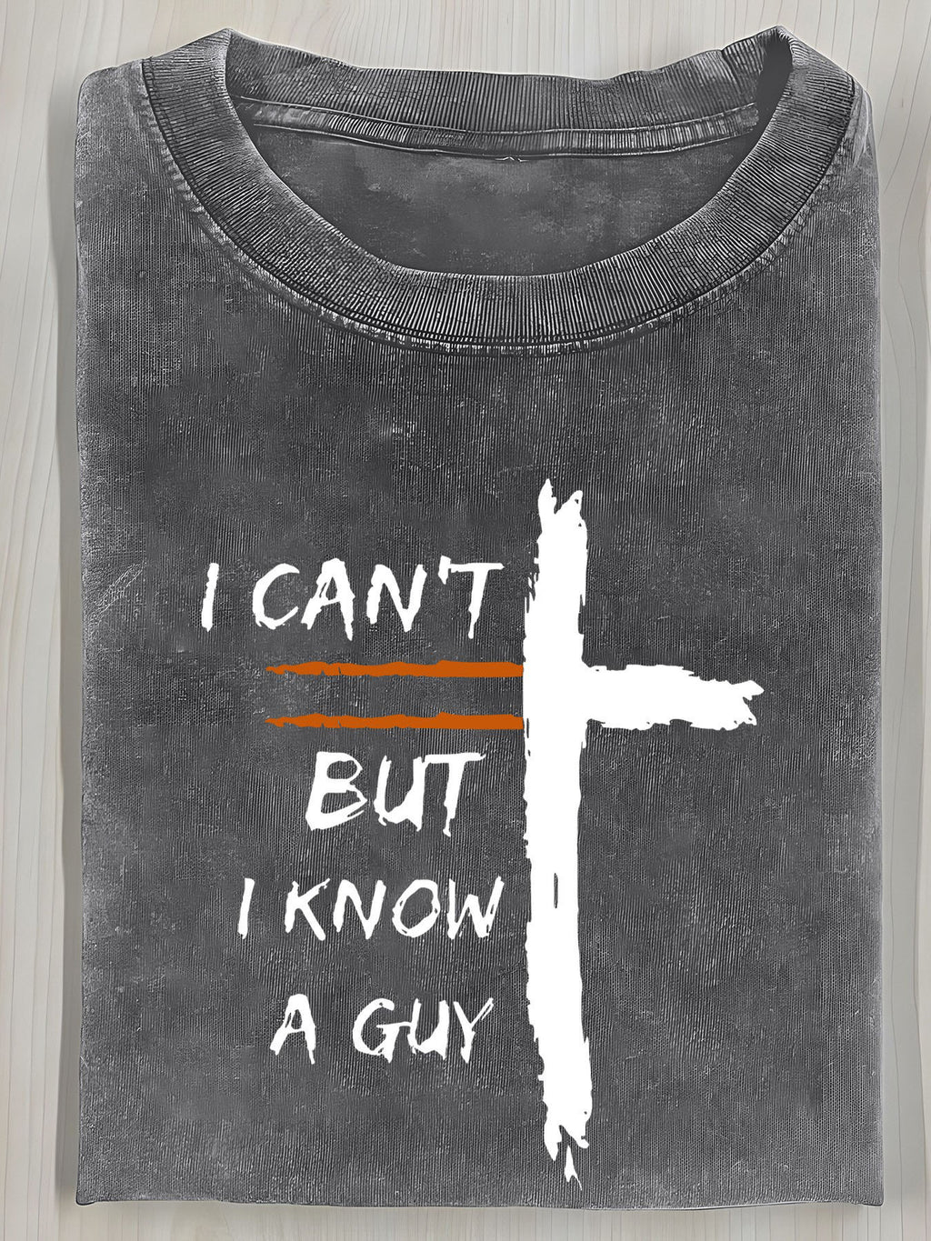 A Vintage Washed T-Shirt Featuring a Cross Print And The Bold Design "I Can'T, But I Know a Guy". It Has a Relaxed Fit, Round Neck, And Short Sleeves, Making It an Ideal Summer Gift for Men.