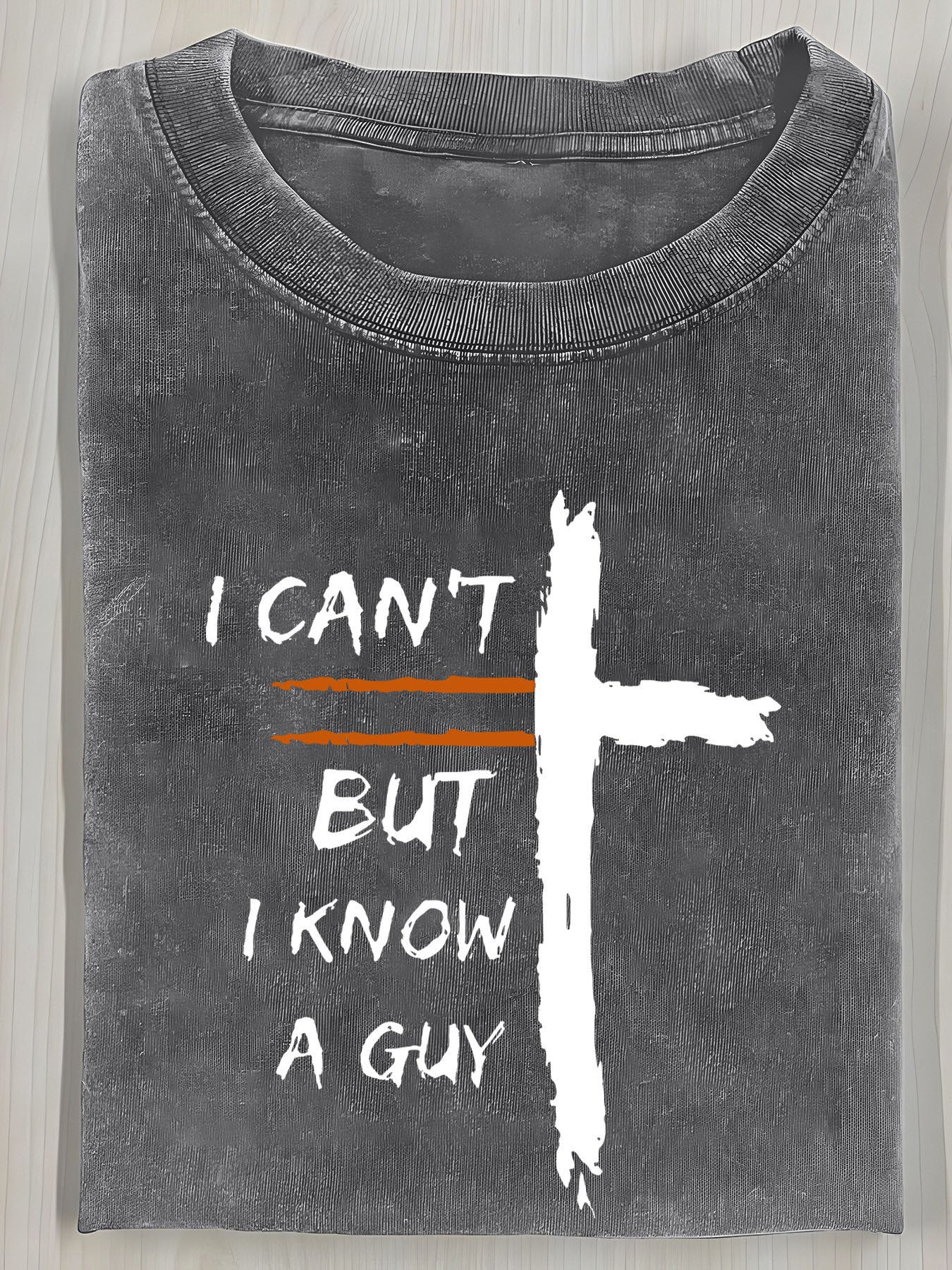 A Vintage Washed T-Shirt Featuring a Cross Print And The Bold Design "I Can'T, But I Know a Guy". It Has a Relaxed Fit, Round Neck, And Short Sleeves, Making It an Ideal Summer Gift for Men.