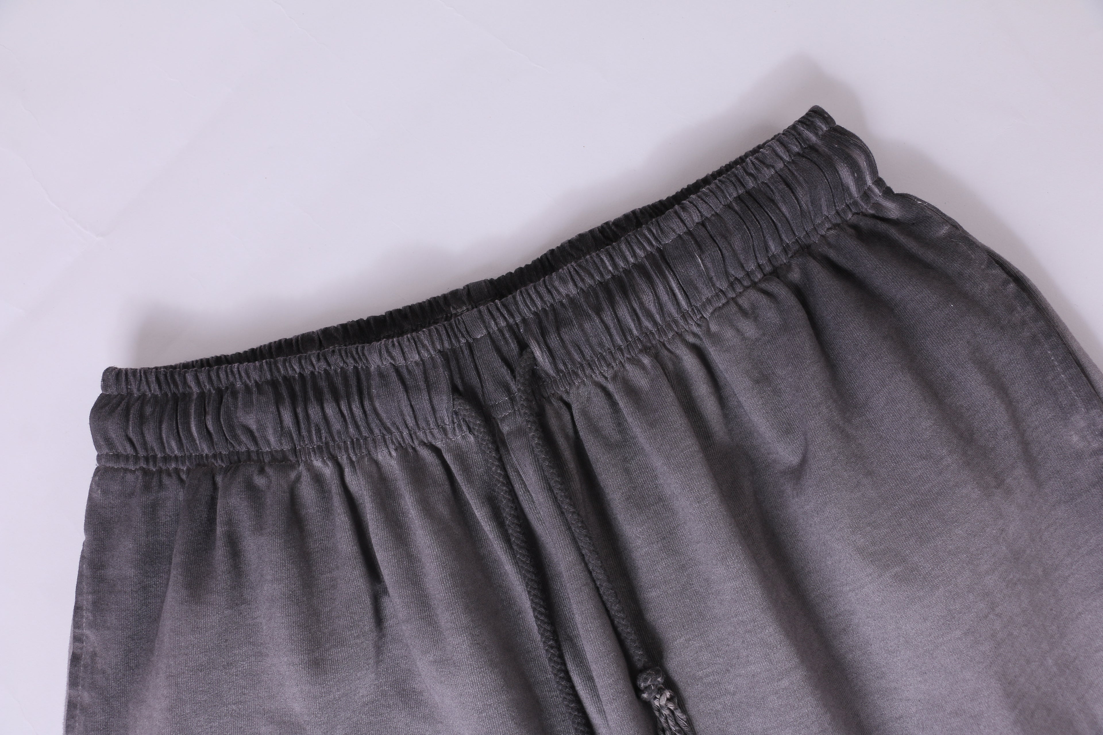 American vintage-style "dirty wash" shorts; distressed, faded, cotton-feel athletic shorts; versatile, casual unisex style.
