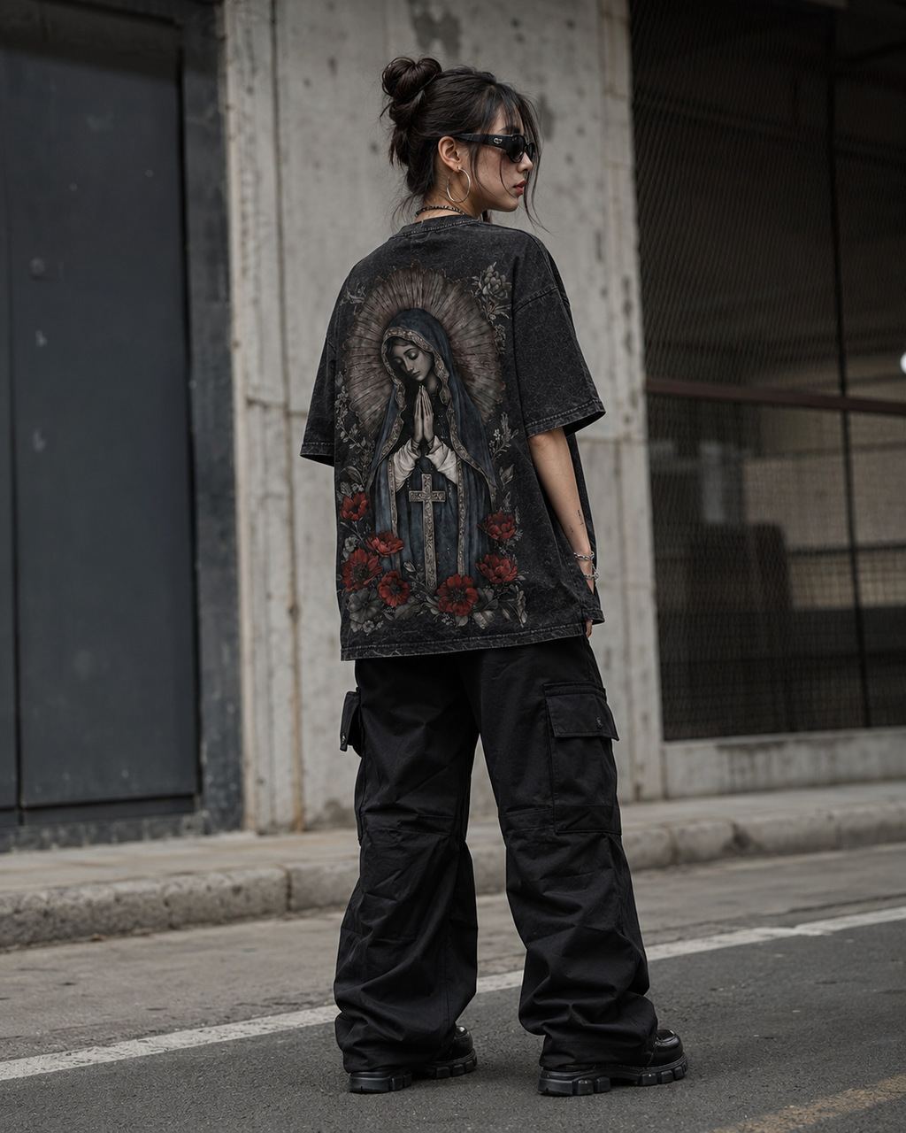 Distressed, vintage-style washed T-shirt featuring a Madonna, floral, and cross print; unisex short-sleeve design.