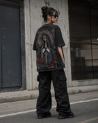 Distressed, vintage-style washed T-shirt featuring a Madonna, floral, and cross print; unisex short-sleeve design.